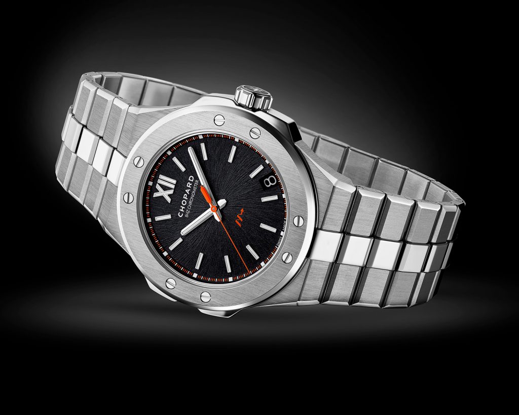 Titanium watch with black dial and silver hour and minute hands, with orange second hand