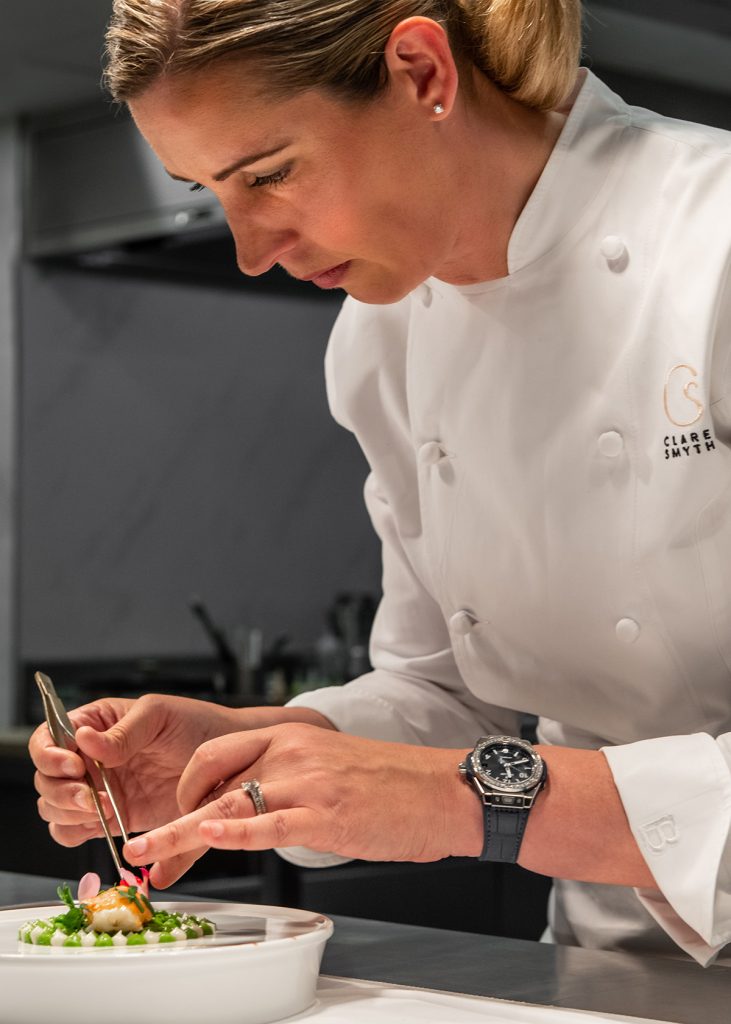 Clare Smyth putting final touches on a white plate