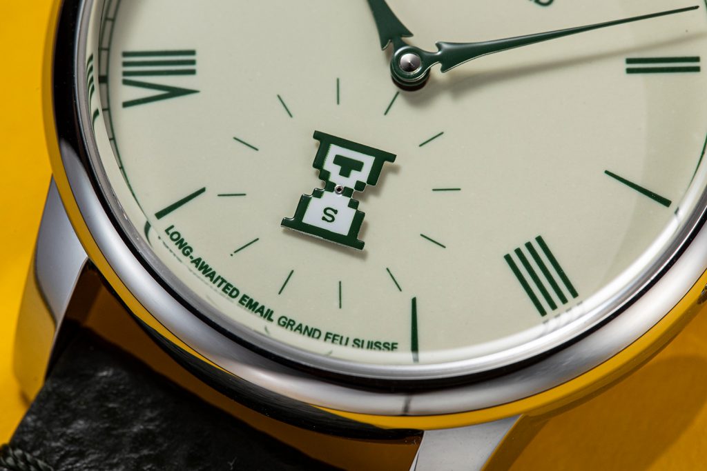 Close-up of the hourglass shaped seconds indicator and "long-awaited email grand feu" inscription