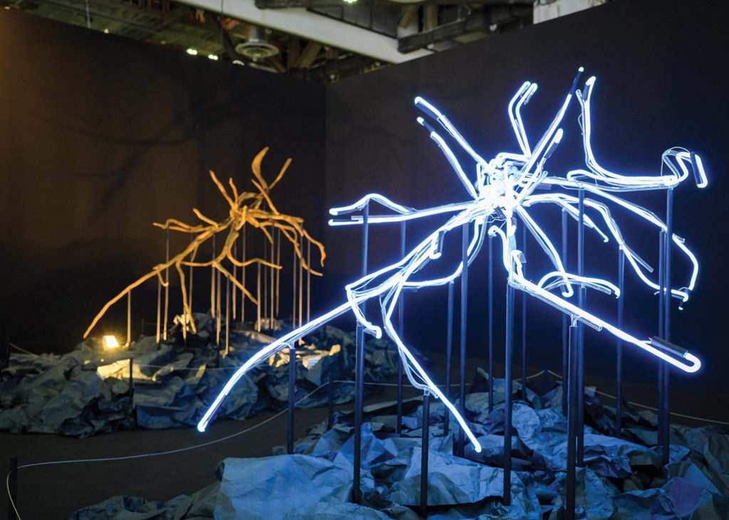light installation based on reconstructed mangrove roots against black backdrop