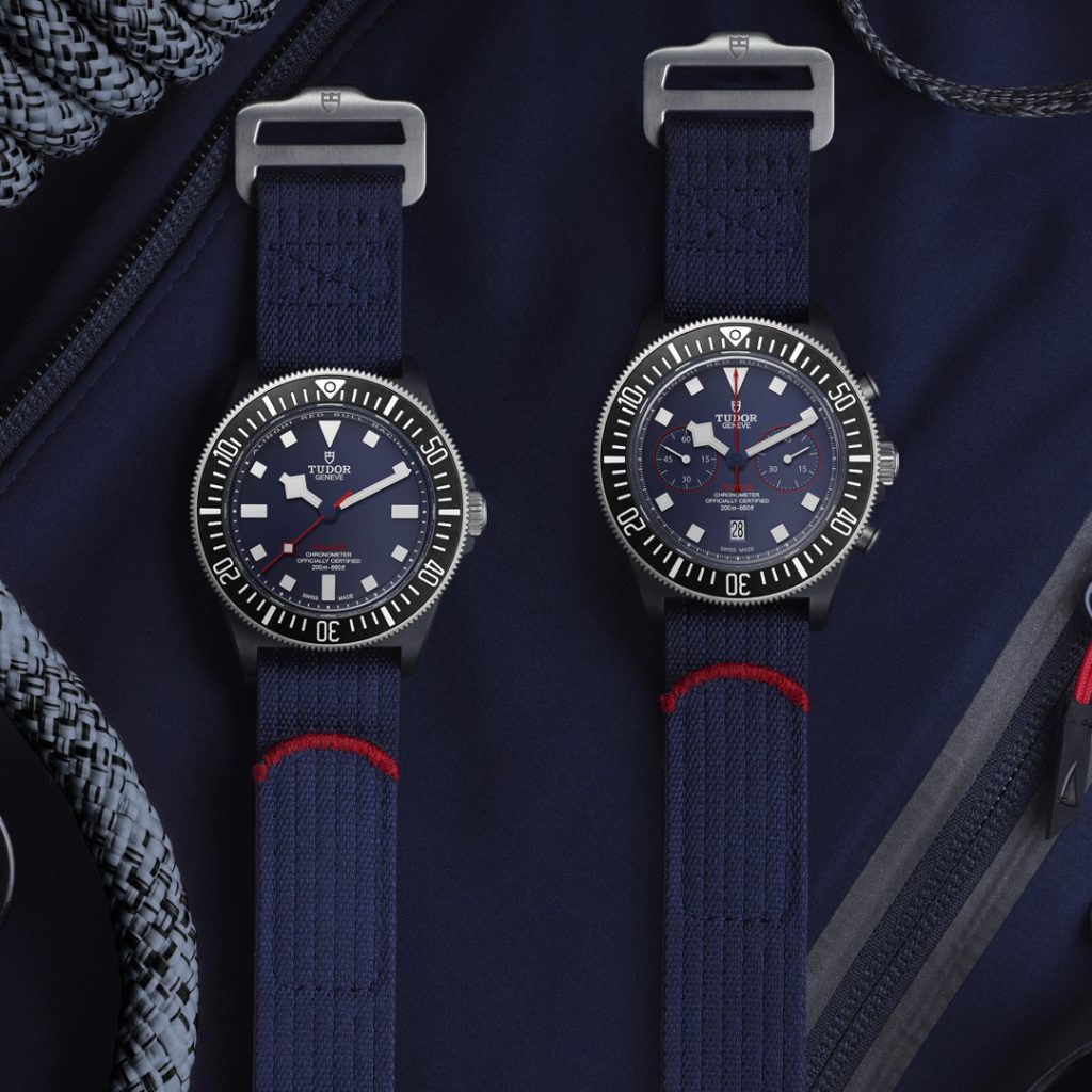 Two blue dial watch with blue woven fabric strap and red accents