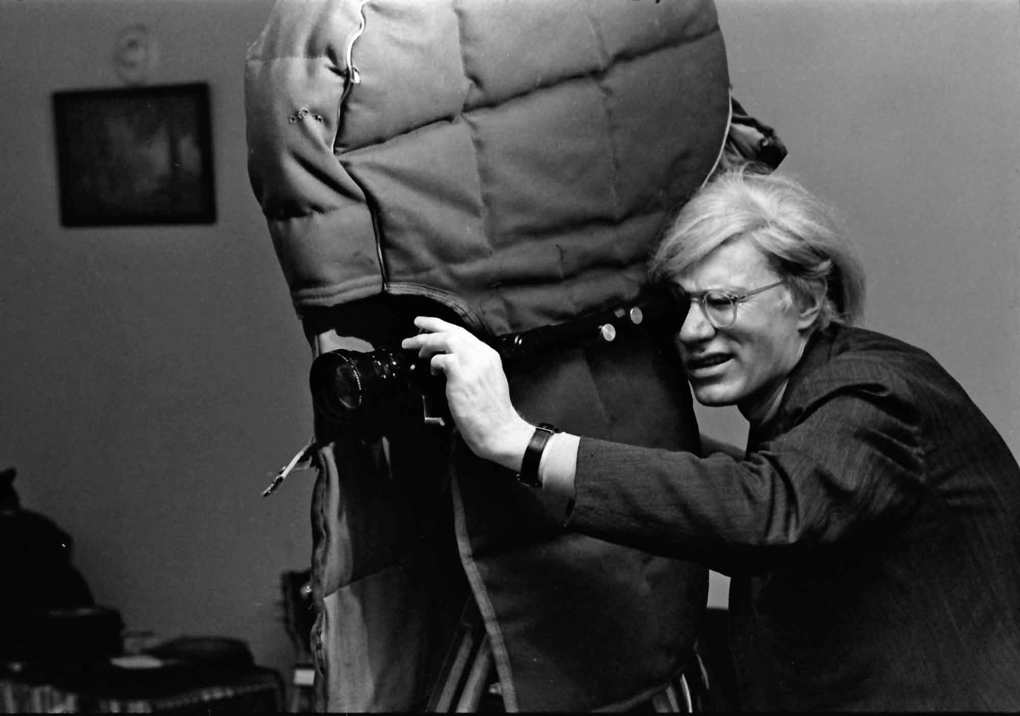 Andy Warhol operating a camera