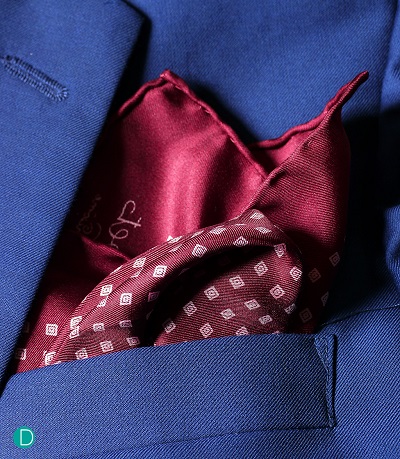 Charvet pocket square.  Note the fine silk material, and the beautiful print.  Also note the hand rolled edges, the very features of a beautiful hand made pocket square.