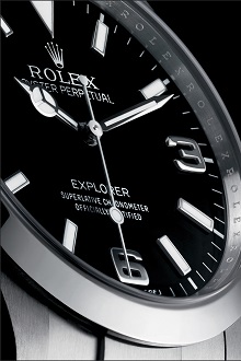 The Rolex Explorer's iconic black dial with Arabic numerals.